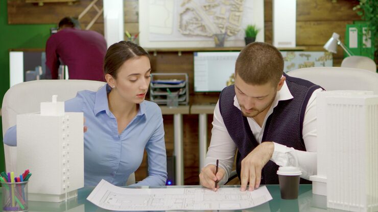 young-talented-architects-changing-plans-business-buildings-architect-drawing-blue-prints_482257-27763